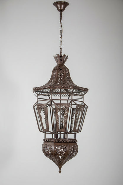 A Moroccan Moorish bronze metal color hanging chandelier with intricate clear glass and metal filigree.