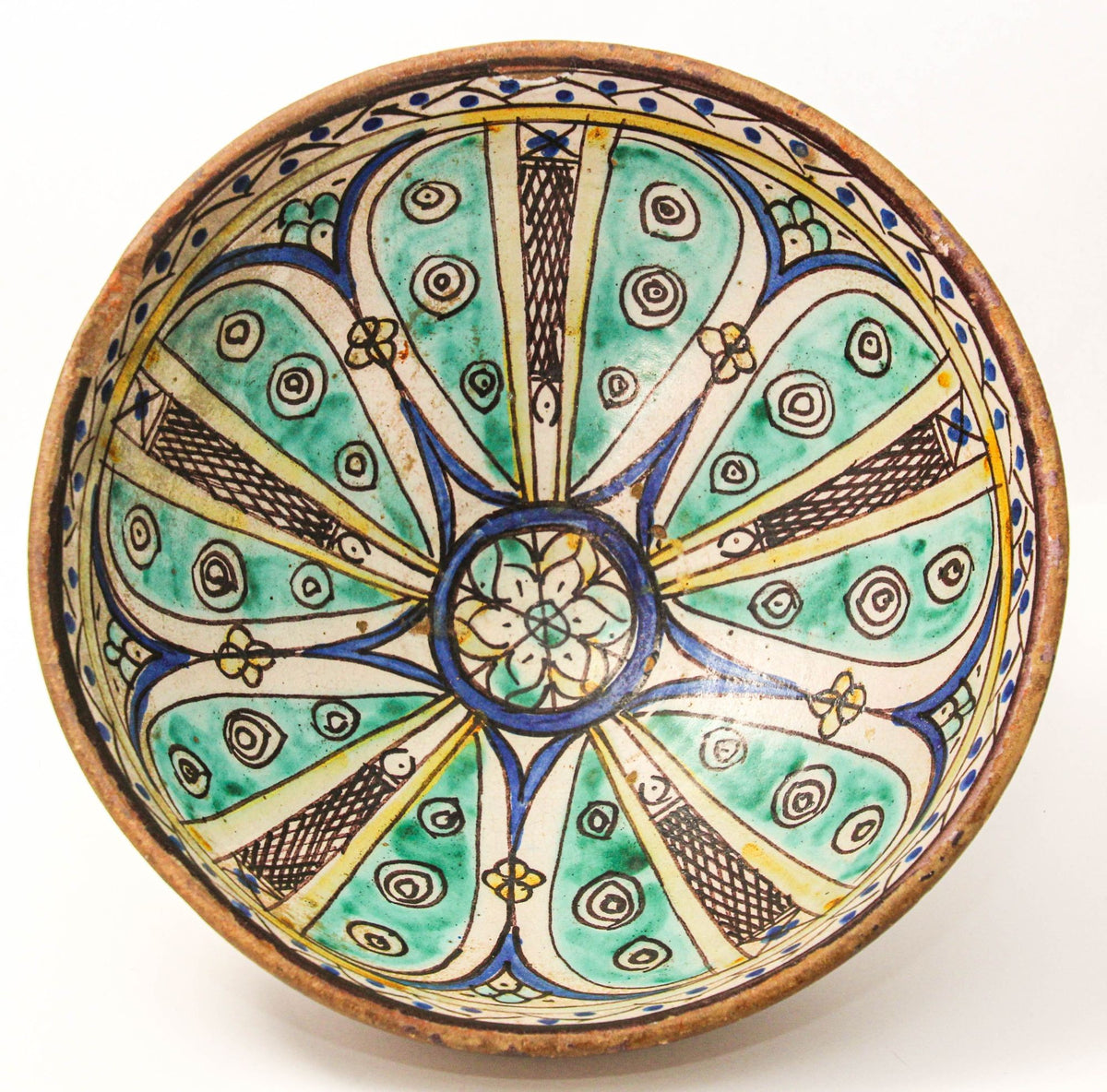 A 19th-century antique ceramic footed bowl from Morocco, with hand-painted polychrome patterns in green, blue, ochre, and brown on a beige and brown base.