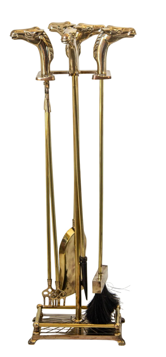 Set of brass fireplace tools including a poker, tongs, and brush 