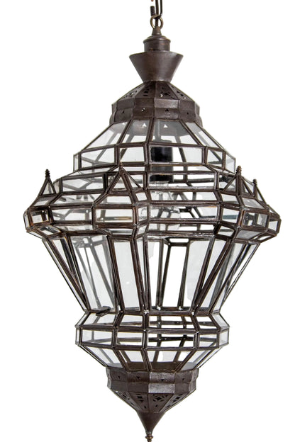 A vintage Moroccan clear glass lantern with a bronze metal finish, in a diamond shape, featuring multifaceted panels.