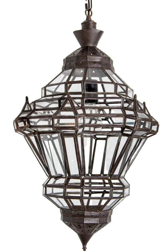 A vintage Moroccan clear glass lantern with a bronze metal finish, in a diamond shape, featuring multifaceted panels.