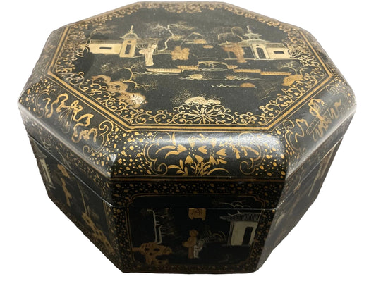 A large Chinese black lacquered octagonal tea box with gold details, featuring hand painted figures and a landscape design on the lid.