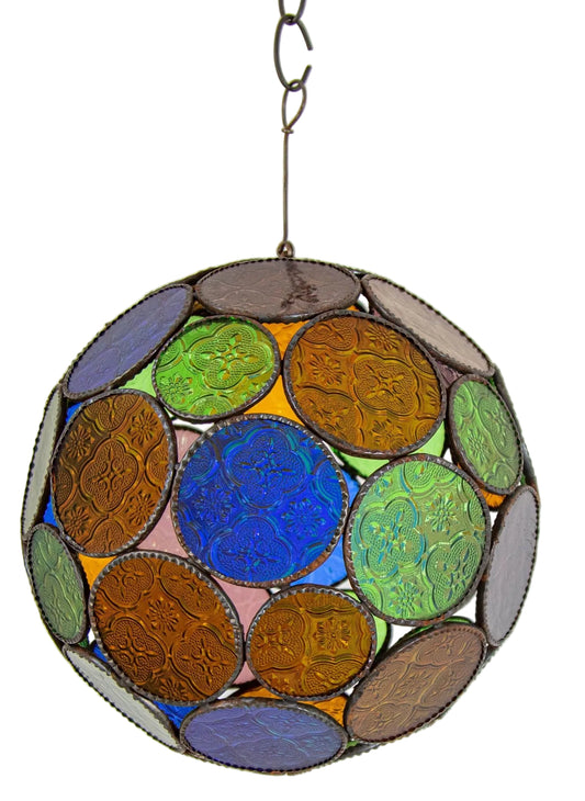 A vintage Moroccan multi-color glass orb lantern with Moorish style, featuring a series of concentric circles and geometric patterns, primarily in blue, green, and amber colors, mounted on a metal hook.