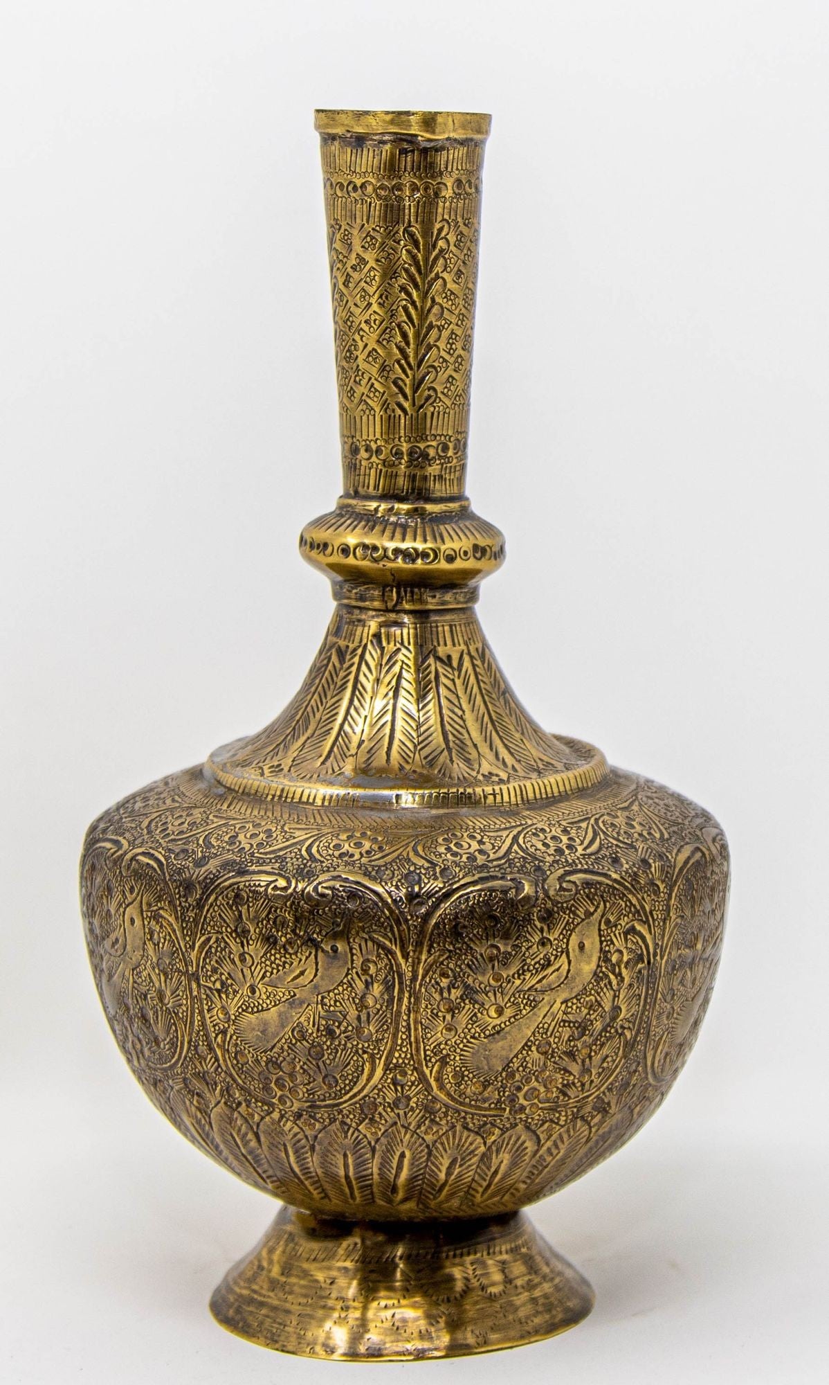 Antique Persian brass engraved vase with intricate foliage and birds, featuring a footed base and a top opening.