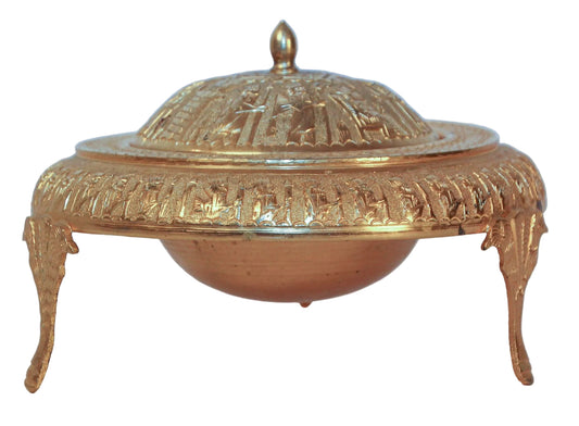 A vintage gold-tone brass Islamic Moorish roll-top caviar footed dish server with intricate decoration and a domed lid, resting on a footed base.