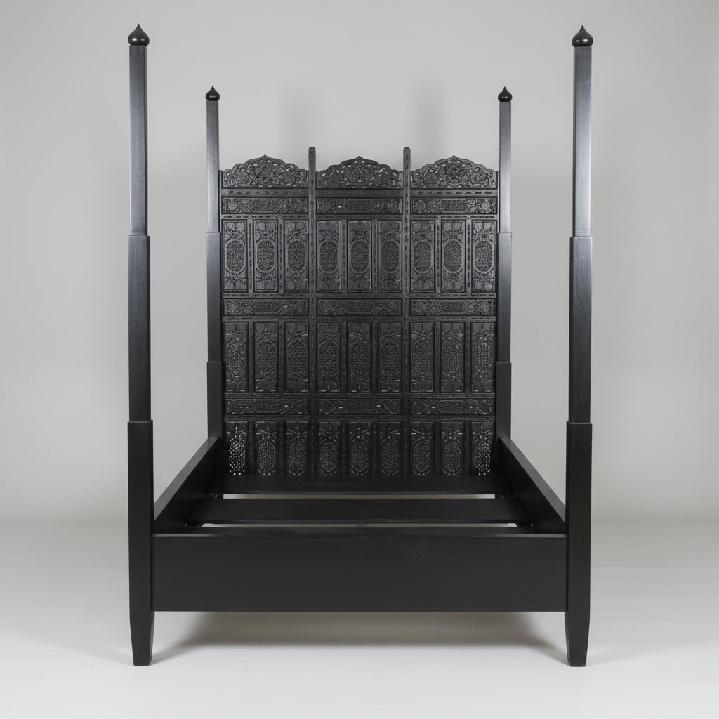 A black four-poster bed with intricate carvings and a Moorish arched head panel, Indo Portuguese Moorish Mughal Raj queen Bed, Anglo Indian hand-carved Bed.