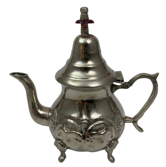 Vintage silver plated Moroccan metal tea pot with brass decorations and a lid, featuring intricate patterns and a burner on top.