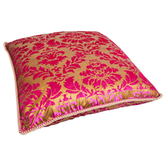An oversized silk square pink and gold floor pillow with a Moorish pattern, featuring a zipper on the side.