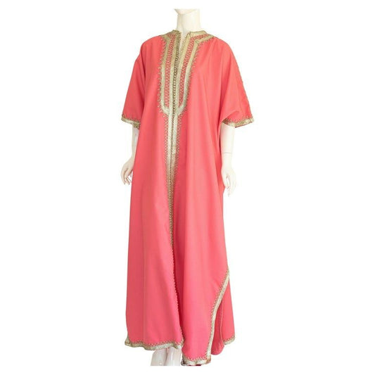 A vintage hot pink Moroccan caftan with silver trim and embroidery, displayed on a mannequin.