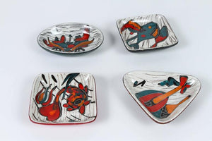 Four Italian Leather Backed Decorative Ceramic Dishes
