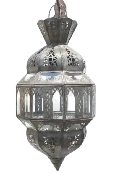 A traditional Moroccan metal lantern with intricate cutout patterns and glass panels, shown against a plain white background.