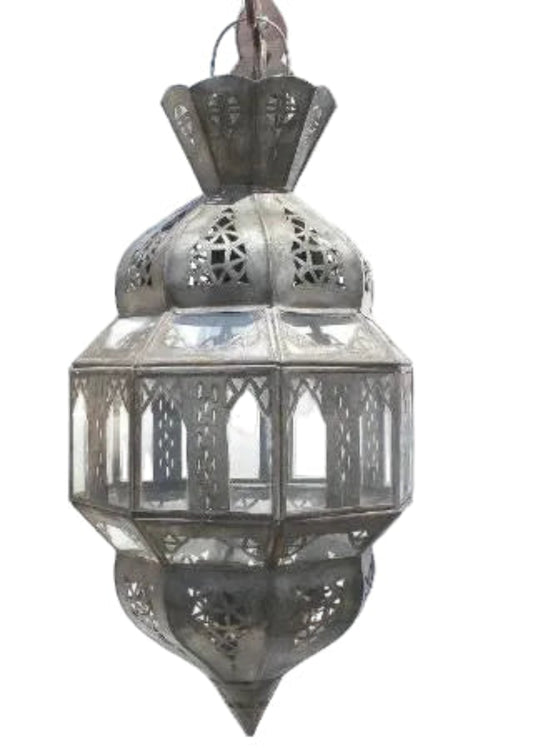 A traditional Moroccan metal lantern with intricate cutout patterns and glass panels, shown against a plain white background.